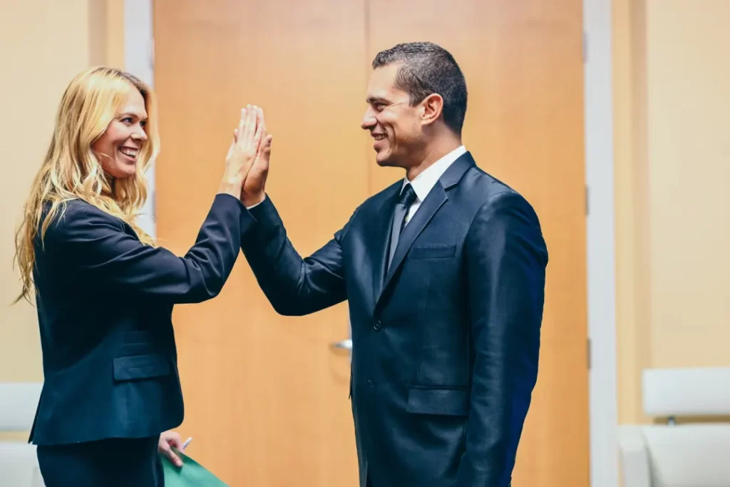 Man and woman shaking hands after successful business deal.